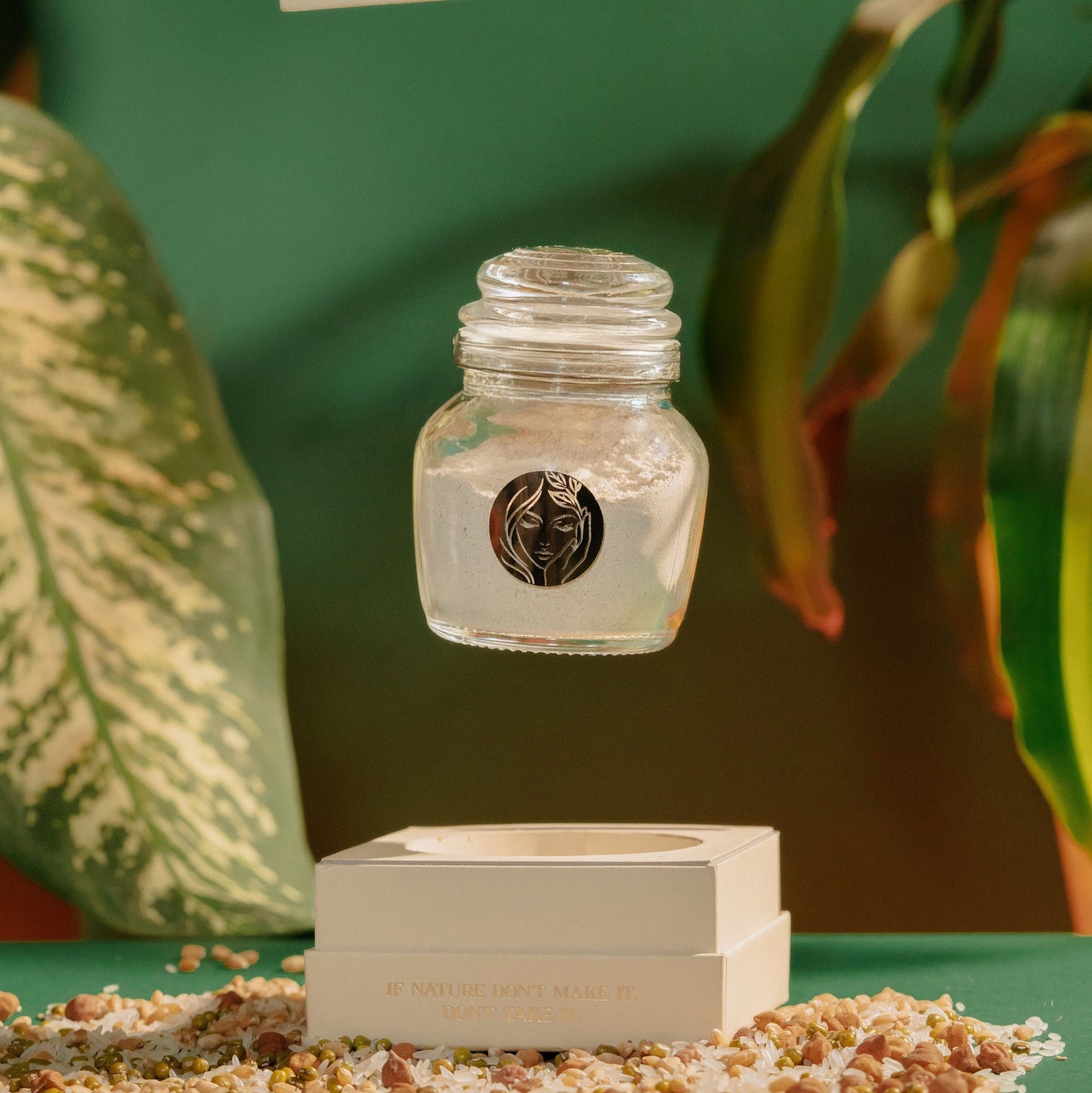 organic ubtaan face pack by prakriti's bottle is floating in the middle of the frame against a green, leafy, forest clean backdrop as it's about to land in the bottom half of the product's box. 