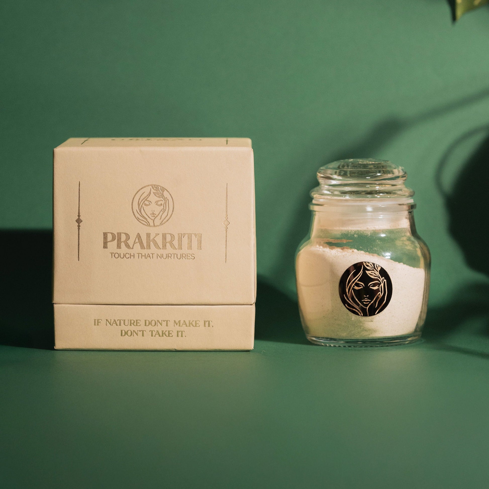 Prakriti's All Natural Face Pack Ubtaan displayed clearly in a box against a grainy texurous green background with some blurred leaves on the top